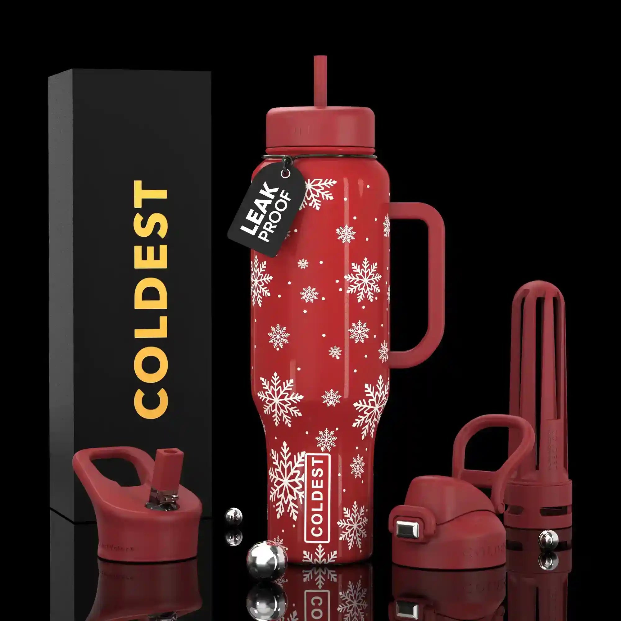 Red insulated bottle with snowflake pattern, packaging, and accessories on a black background