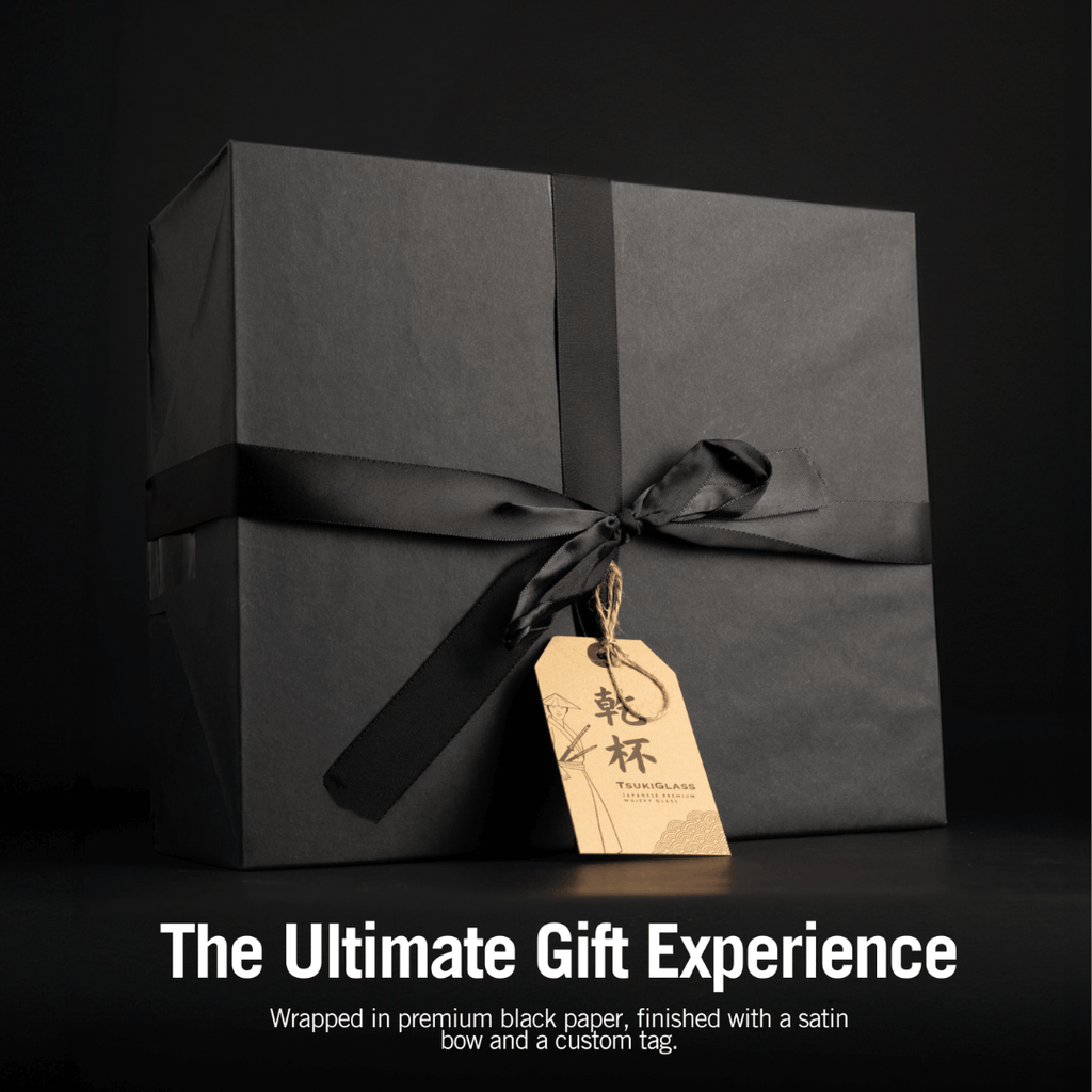 Black gift box with satin bow and custom tag on a dark background, featuring text about the ultimate gift experience.
