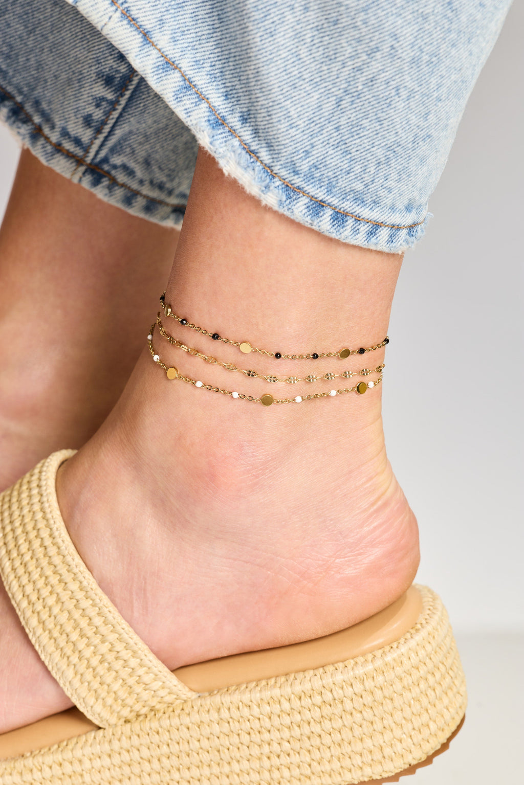 Anchors bracelet on a foot with a casual outfit