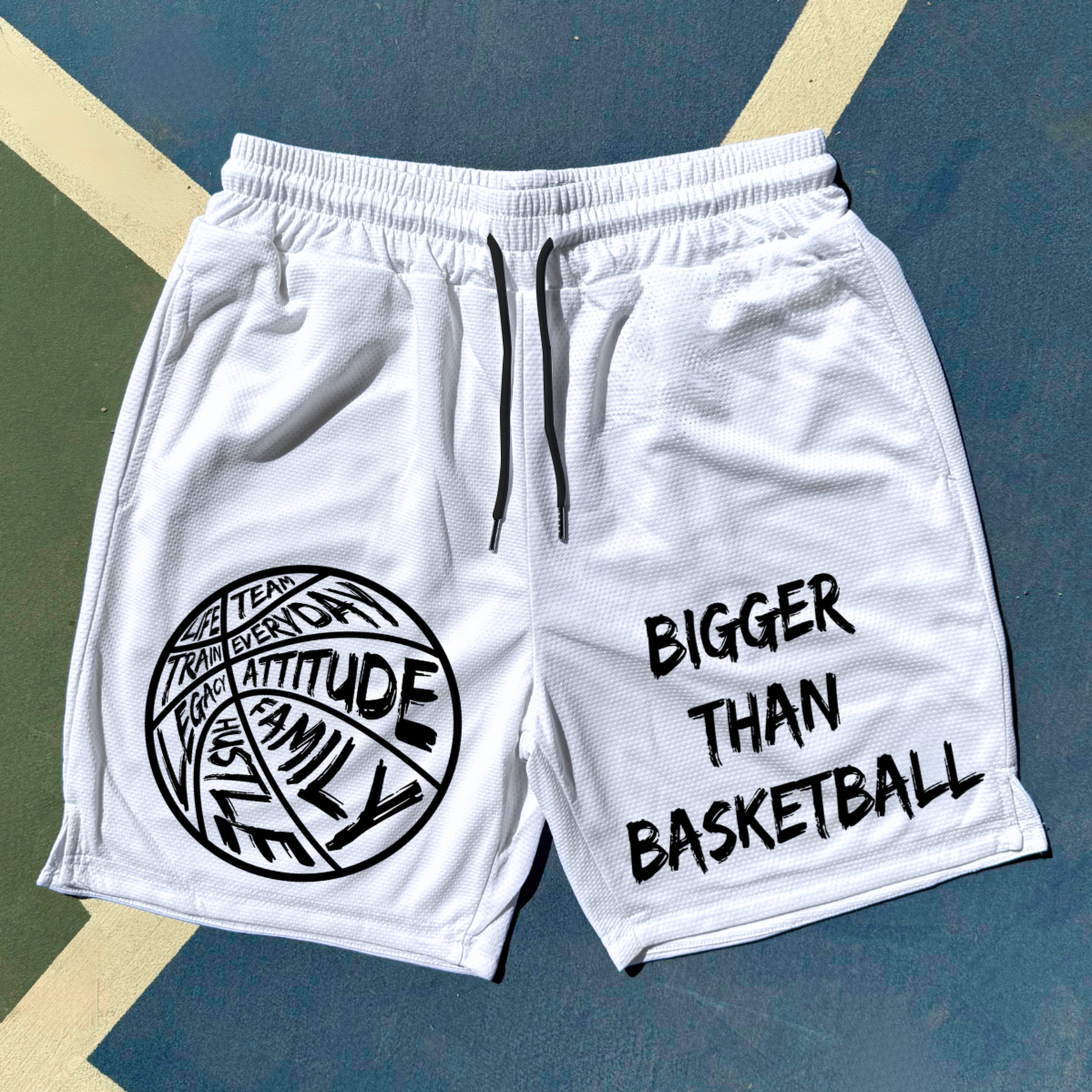 White shorts with black text and graphics on a blue and green background