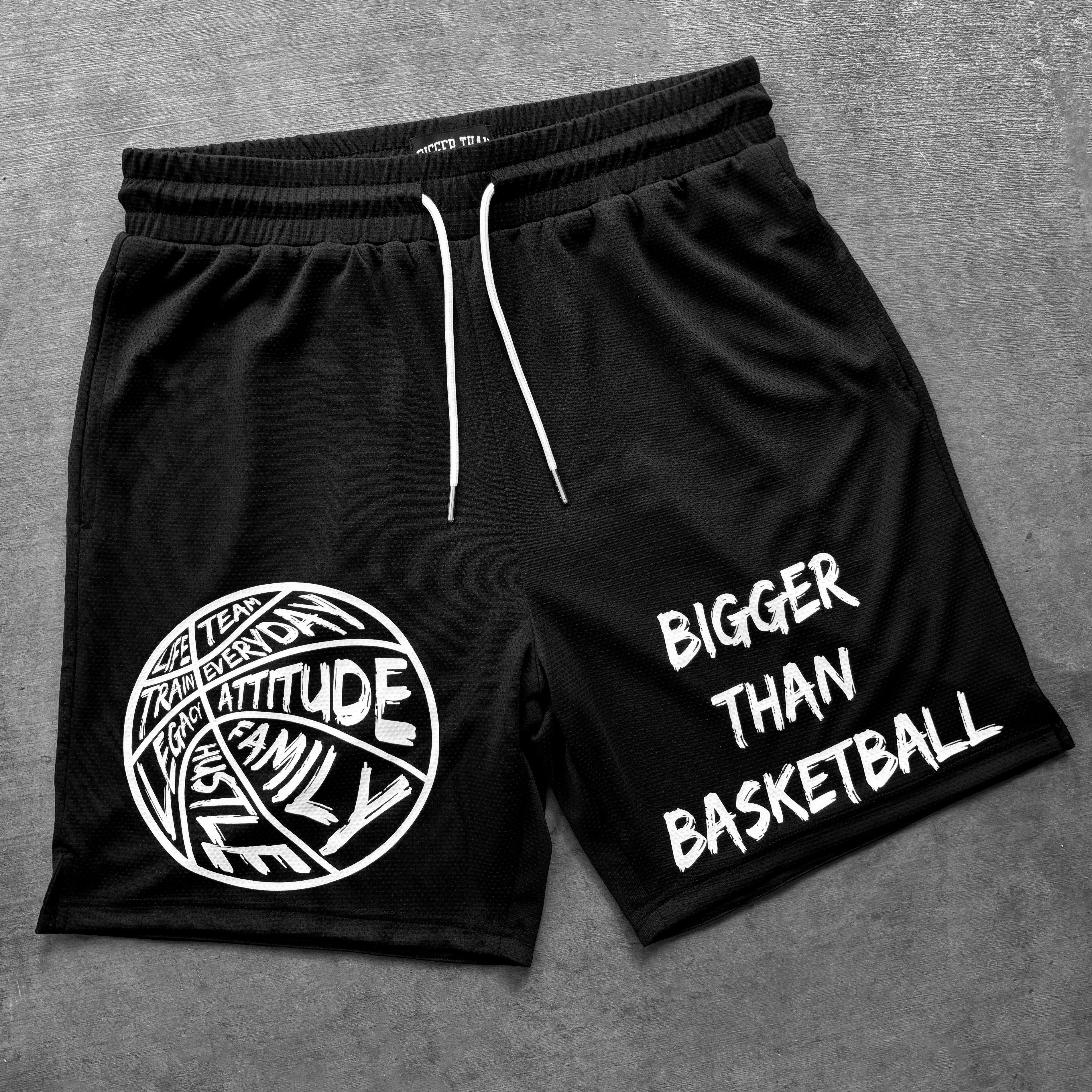 Black shorts with white text and graphics on a gray background