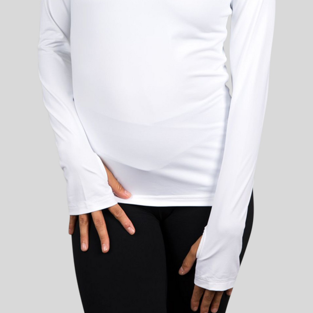Person wearing a white long-sleeve top and black pants on a light gray background