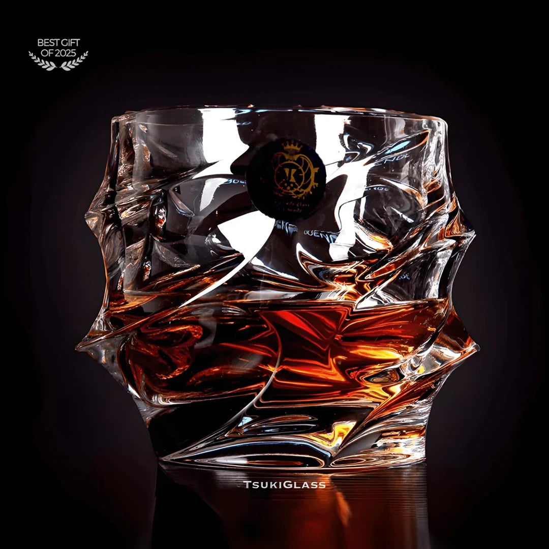 Crystal glass with liquid inside on a dark background, featuring the brand 'TsukiGlass'.