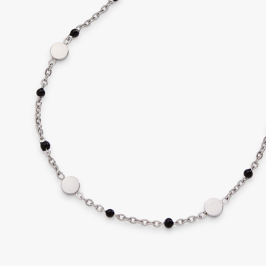 Necklace with white and black beads on a white background