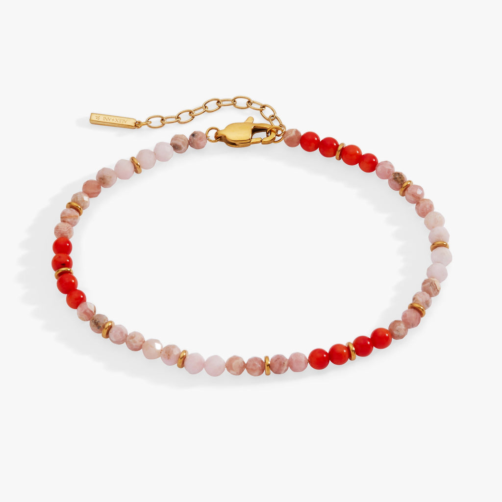 Beaded bracelet with red and pink stones on a white background