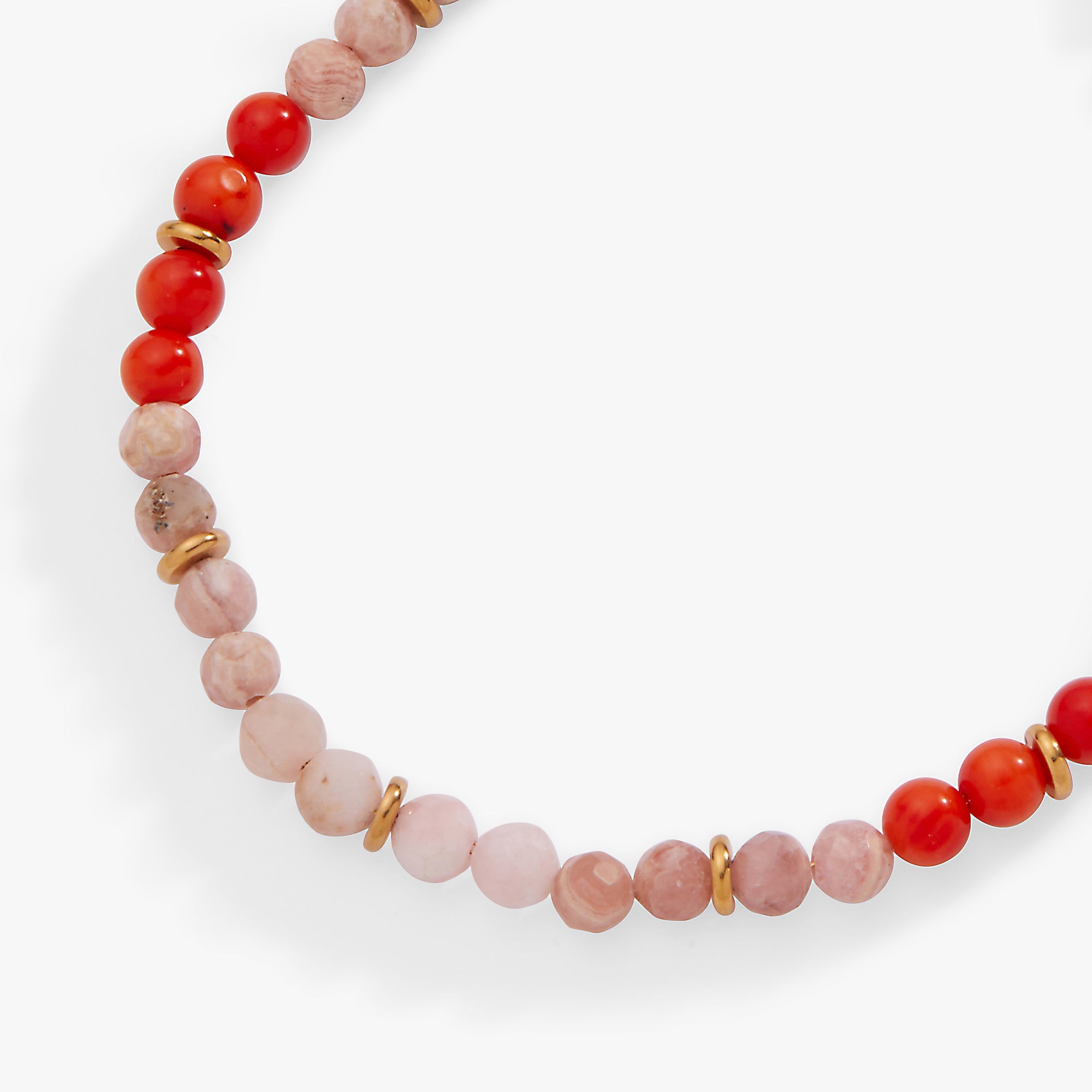 Necklace with red and pink beads on a white background