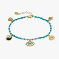 Bracelet with turquoise beads and various charms on a white background