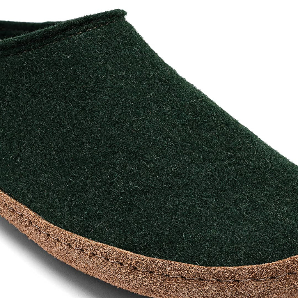 Dark green slipper with brown sole on a white background