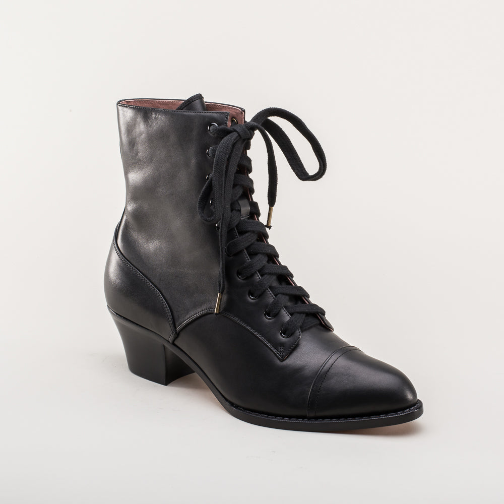 Black leather lace-up boot on a light gray background