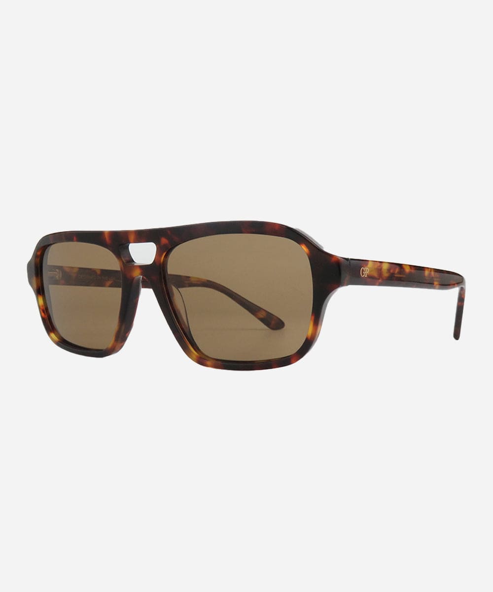 Sunglasses with tortoiseshell frame and brown lenses on a white background