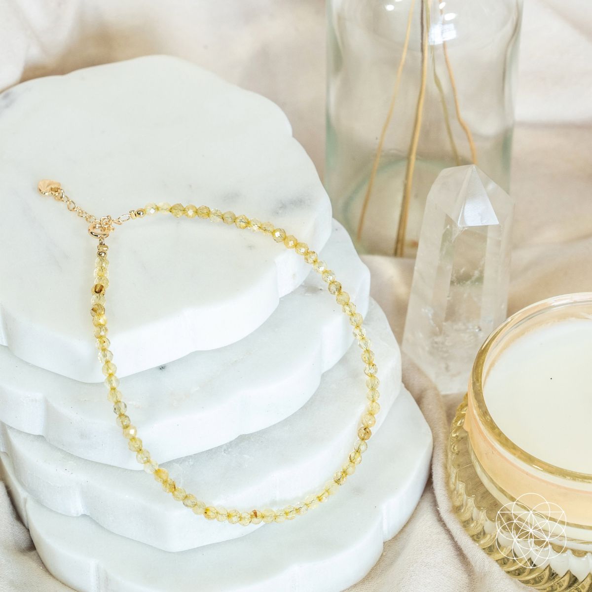 Gold necklace on a white stone with a soft focus background